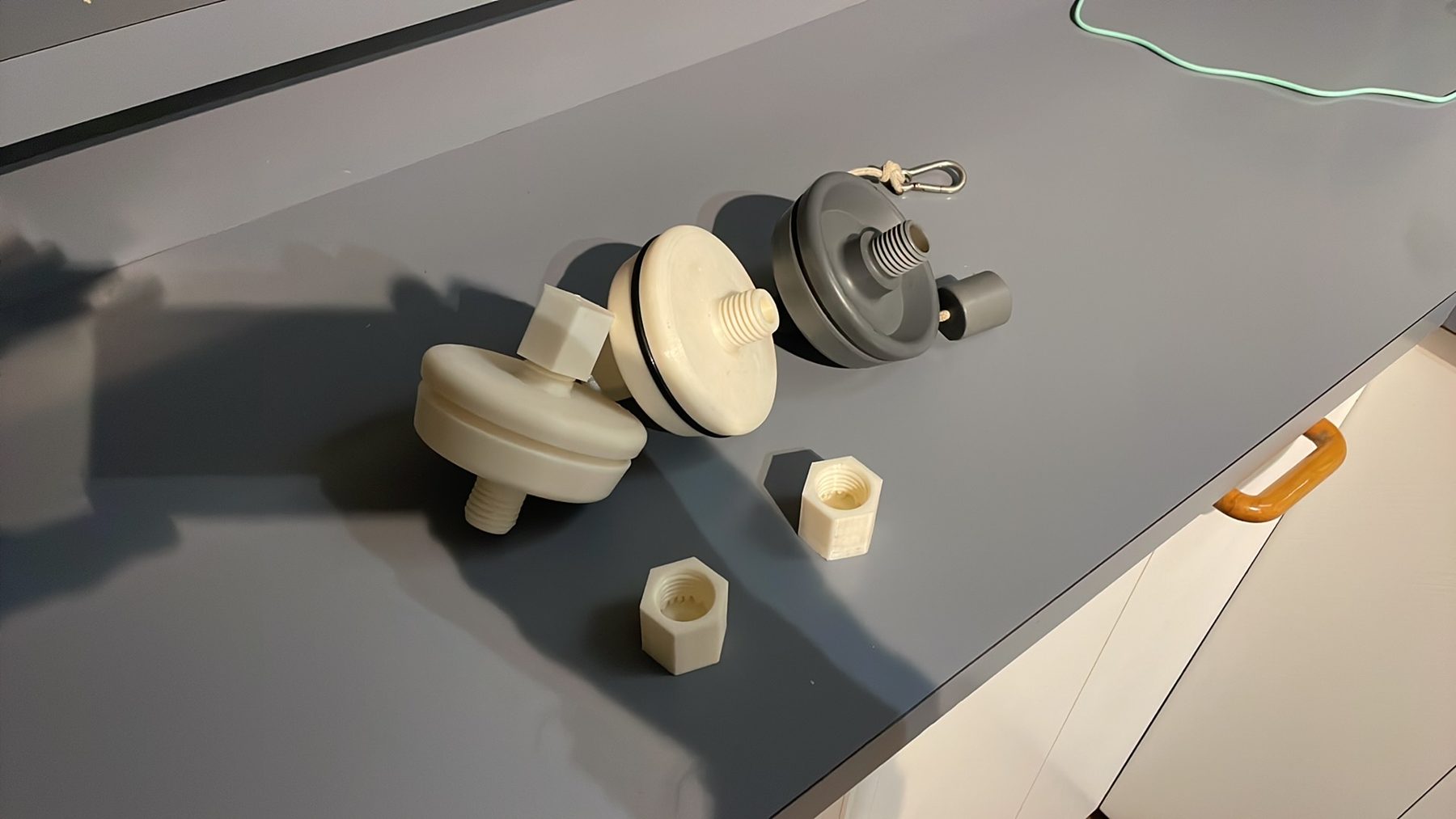 A set of printed threaded caps and fittings laid out for fit-checking